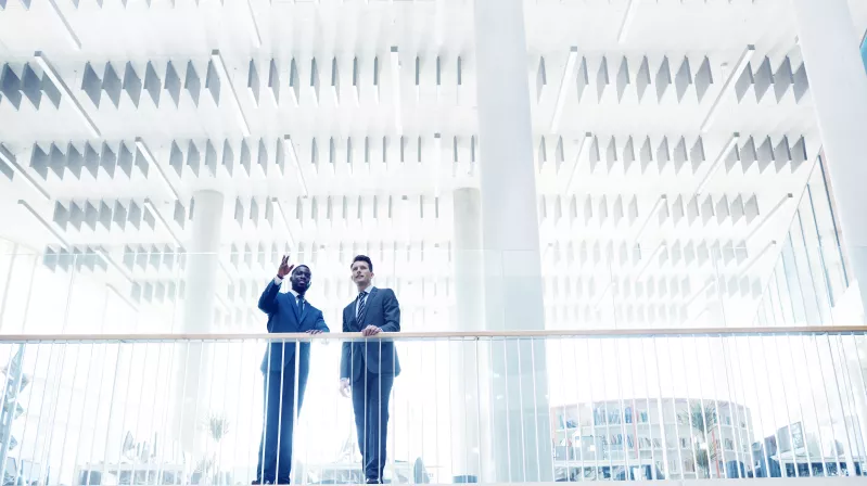 image of two men talking on a bridge